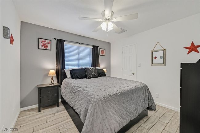 Bedroom with wood finish floors, baseboards, and ceiling fan | Image 21