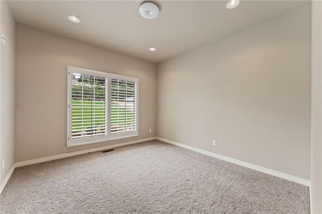 Carpeted spare room featuring visible vents, recessed lighting, and baseboards | Image 32