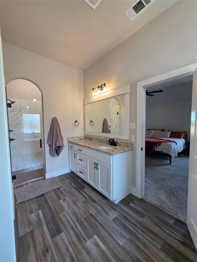 Ensuite bathroom with vanity, a shower stall, and wood finished floors | Image 23