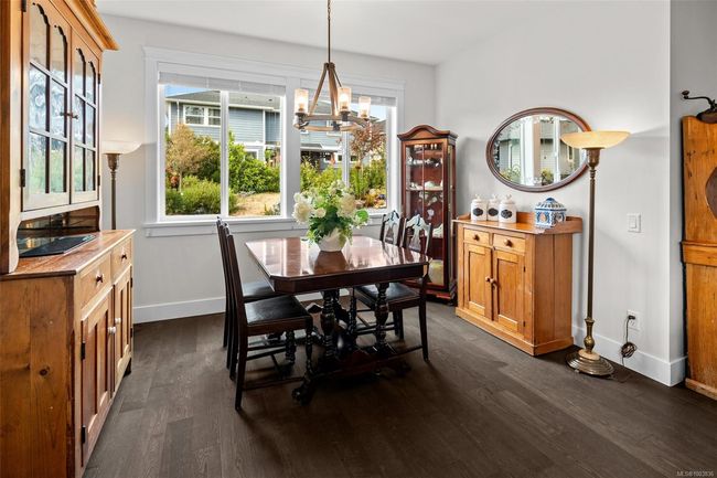 Dining space with a chandelier and dark wood finished floors | Image 20