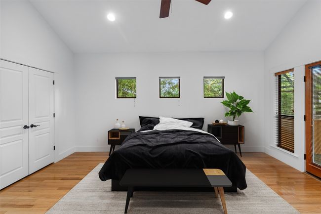 Primary bedroom featuring recessed lighting and french doors that lead to the back screened in porch. | Image 14