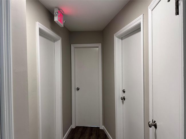 Hall featuring dark wood-style floors and baseboards | Image 20