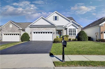 View of front of home with a garage and a front yard | Image 1