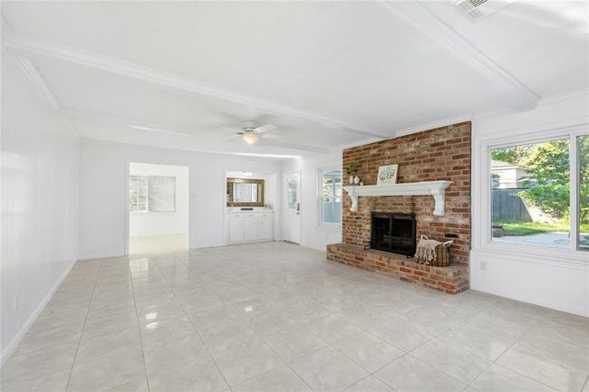 Another photo looking into the dining room.Living area boost a wood burning fireplace, new paint and fixtures | Image 12