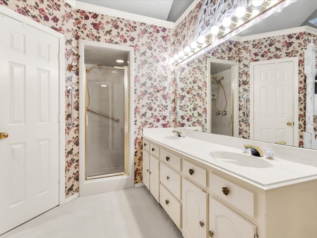Primary bathroom features long vanity with dual sinks and separate shower. | Image 27
