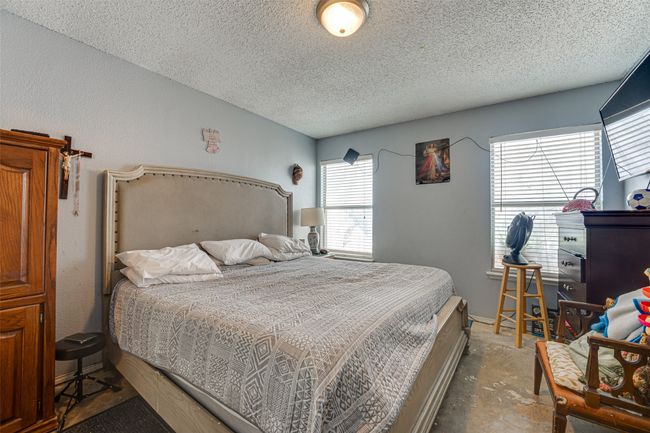 Bedroom with a textured ceiling | Image 11