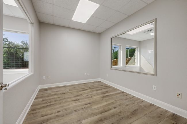 Empty room featuring baseboards, wood finished floors, and a drop ceiling | Image 24