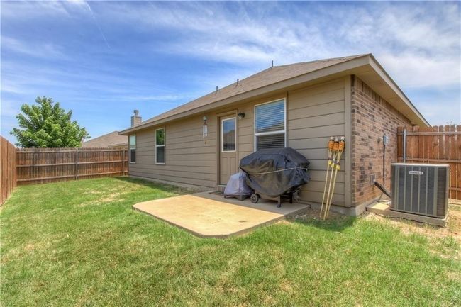 Back of property with a patio, a fenced backyard, and brick siding | Image 16