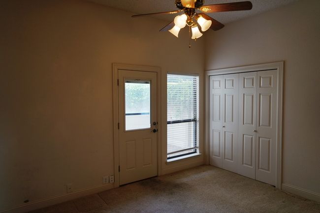 Foyer entrance featuring healthy amount of natural light, ceiling fan, light colored carpet, and baseboards | Image 18