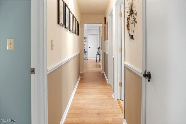 Corridor with baseboards and light wood-style floors | Image 24