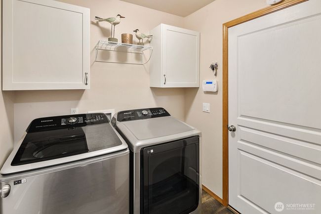 Downstairs laundry room with access to garage. | Image 23