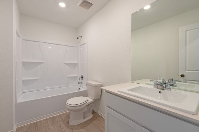 Bathroom with toilet, vanity, wood finished floors, and shower / bath combination | Image 21