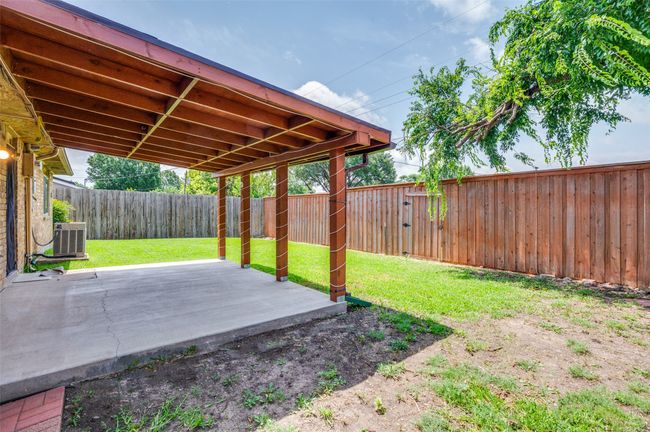 Fenced backyard with a patio | Image 5