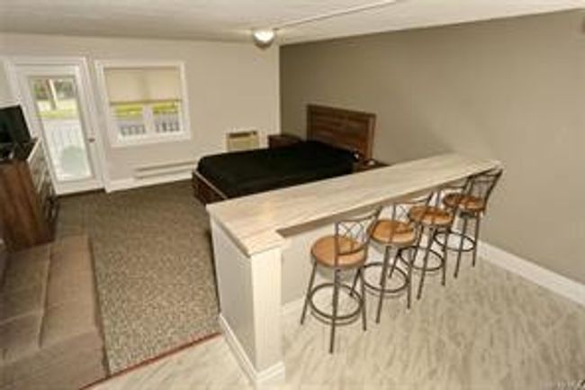 The eating counter overlooks the Living/Bedroom area. | Image 4