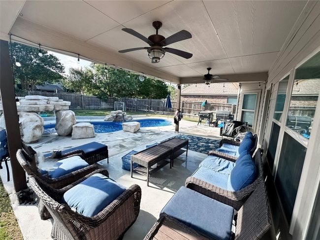Fenced backyard with an outdoor hangout area, a patio, and ceiling fan | Image 27