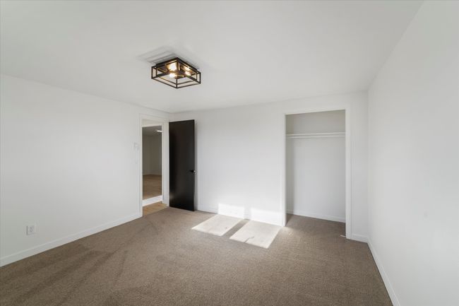 Unfurnished bedroom featuring a closet and carpet flooring | Image 36