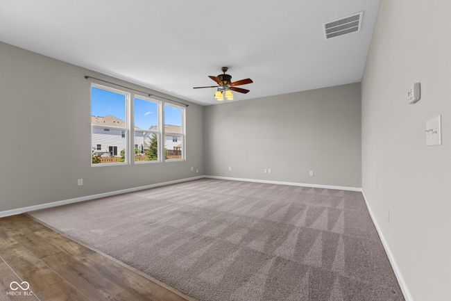 Great room with a ceiling fan and baseboards | Image 8