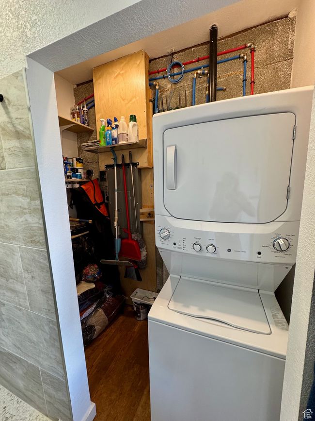 Laundry area with stacked washer / drying machine and storage | Image 20