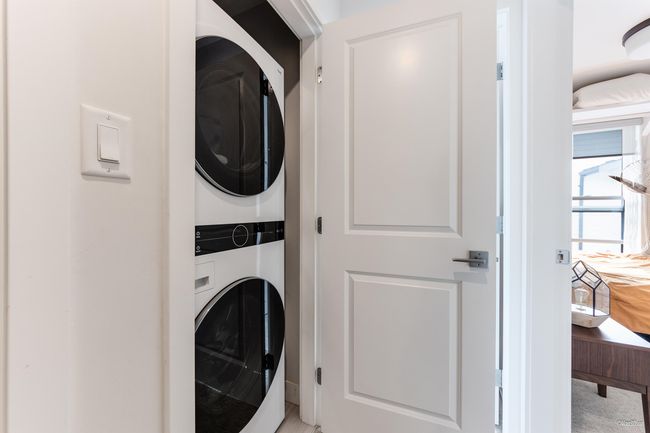 Clothes washing area featuring stacked washer / dryer and laundry area | Image 29