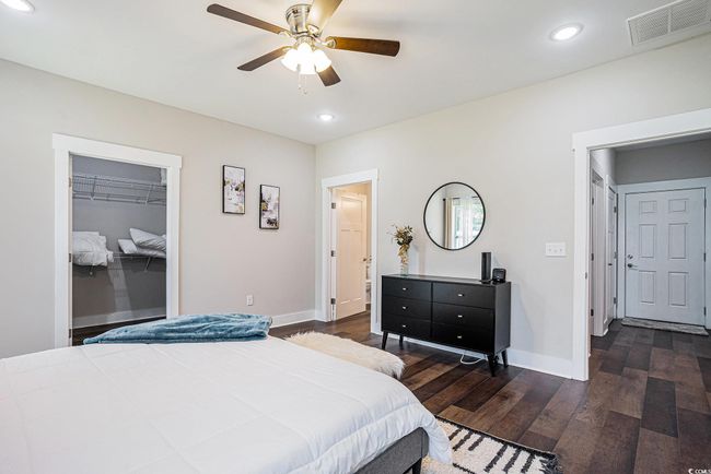 Bedroom featuring dark wood-style floors, recessed lighting, a spacious closet, a ceiling fan, and a closet | Image 13