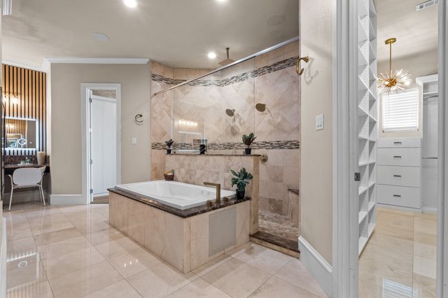 Bathroom featuring a bath, a walk in shower, crown molding, and recessed lighting | Image 18