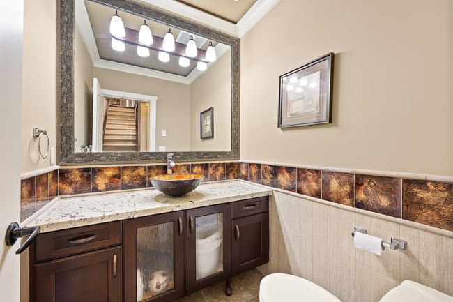 Half bathroom with ornamental molding, vanity, and a wainscoted wall | Image 28
