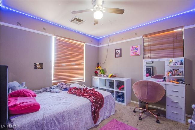 Carpeted bedroom featuring ceiling fan | Image 12