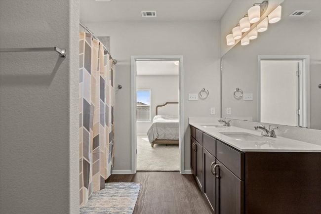 Bathroom featuring wood finished floors, double vanity, connected bathroom, and baseboards | Image 19