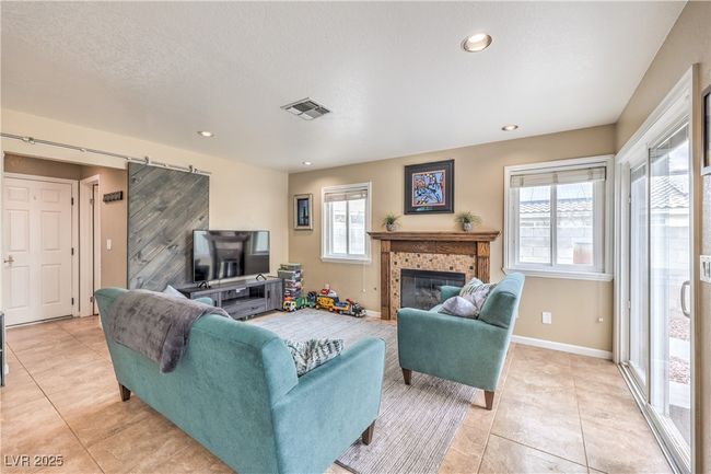 Living area featuring visible baseboards, a healthy amount of sunlight, and light tile patterned flooring | Image 14