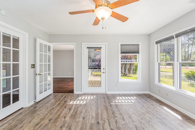 Unfurnished sunroom with a wealth of natural light and french doors | Image 21