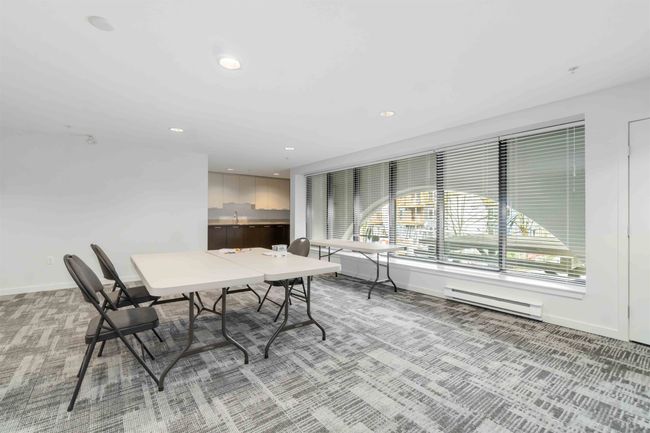 Interior space featuring light carpet, baseboards, a baseboard heating unit, and recessed lighting | Image 29