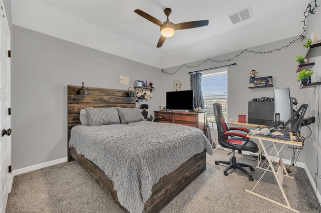 Bedroom with visible vents, baseboards, a ceiling fan, and carpet flooring | Image 24