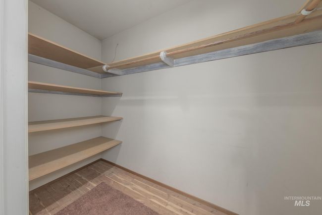 Spacious closet with wood finished floors | Image 16