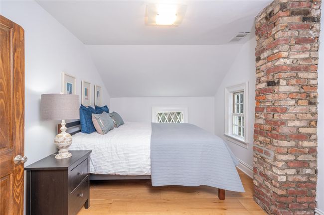Primary Bedroom with exposed brick | Image 16