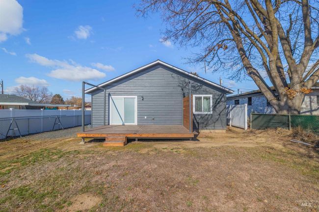 Rear view of house featuring a fenced backyard and a wooden deck | Image 24