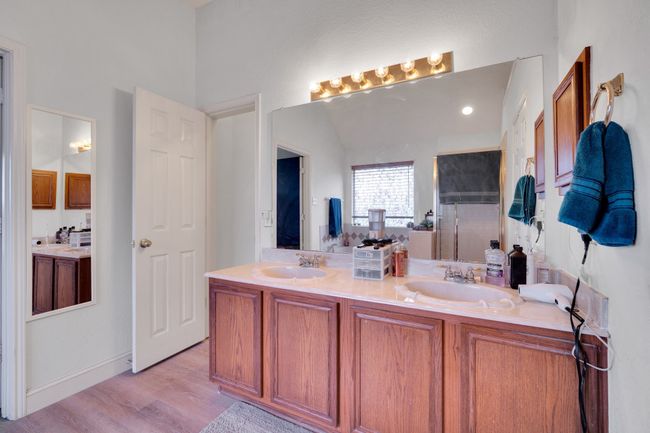 Bathroom with double vanity, wood finished floors, and a shower | Image 29