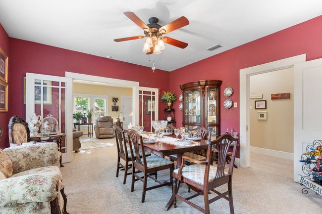 Dining area featuring light carpet and ceiling fan | Image 12
