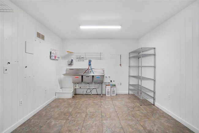 Storage space with commercial grade dishwashing sinks | Image 12