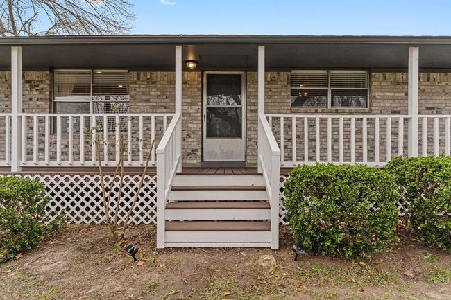 Charming home with a welcoming front porch offering a cozy and inviting exterior. | Image 8
