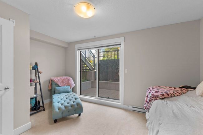 Carpeted bedroom featuring baseboard heating, baseboards, and access to exterior | Image 18
