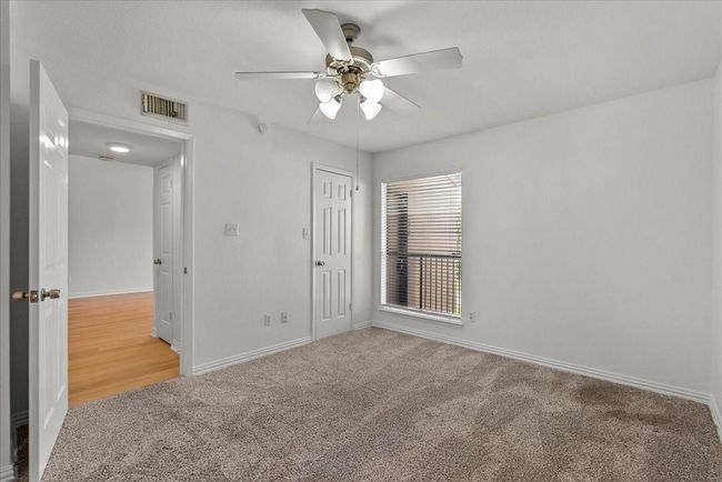 Comfortable second bedroom with plush carpet | Image 22