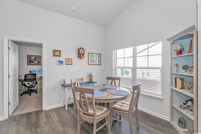 Dining room featuring dark wood-type flooring and lofted ceiling | Image 6