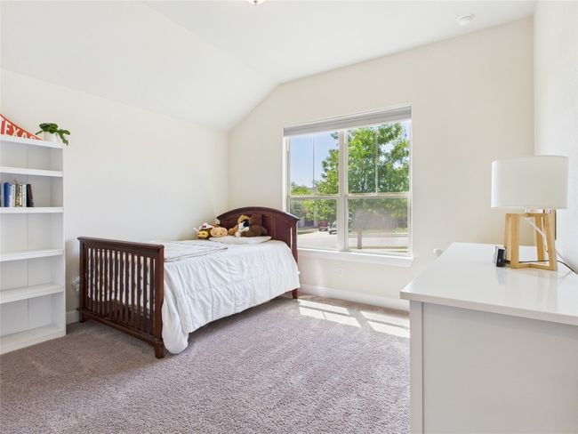 Bedroom featuring baseboards, carpet floors, and vaulted ceiling | Image 13