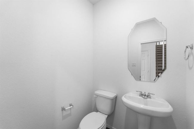 This charming home features a beautifully appointed half bath adjacent to the family room, perfect for welcoming guests and adding convenience to your daily life. | Image 6