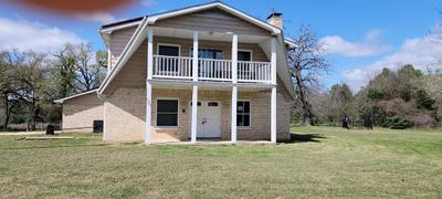 View of front of home featuring a front yard and a balcony | Image 2