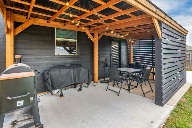 View of patio with outdoor dining area and area for grilling | Image 28
