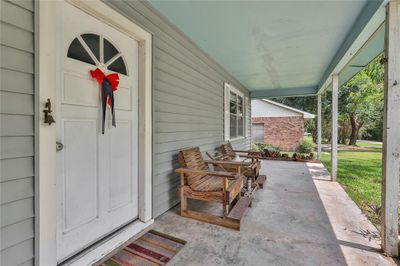 The covered front porch is a nice place to sit and relax out of the sun | Image 3