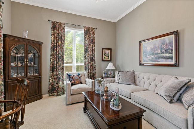 Elegant formal living room with high ceilings, perfect for entertaining or as a quiet study. The sophisticated space offers timeless appeal and flexible functionality to suit your lifestyle needs. | Image 6