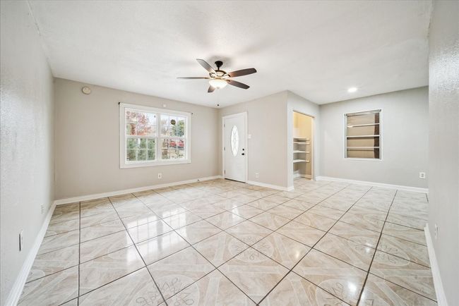 Spare room with a ceiling fan and a smoke detector | Image 6