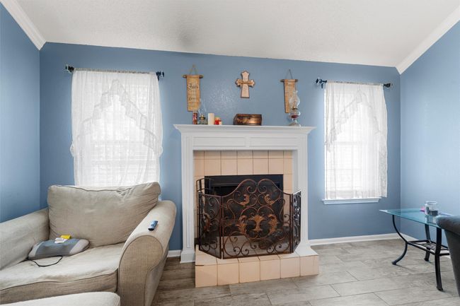 Living area with crown molding, a fireplace, and​​‌​​​​‌​​‌‌​‌‌​​​‌‌​​‌‌​‌​​​​​‌ baseboards | Image 5